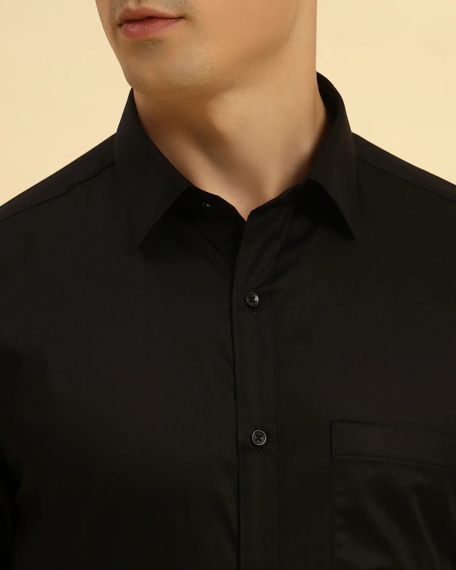 Close-up of the pointed collar and smooth Giza cotton satin fabric texture on the Aeternum Men's Black Shirt.