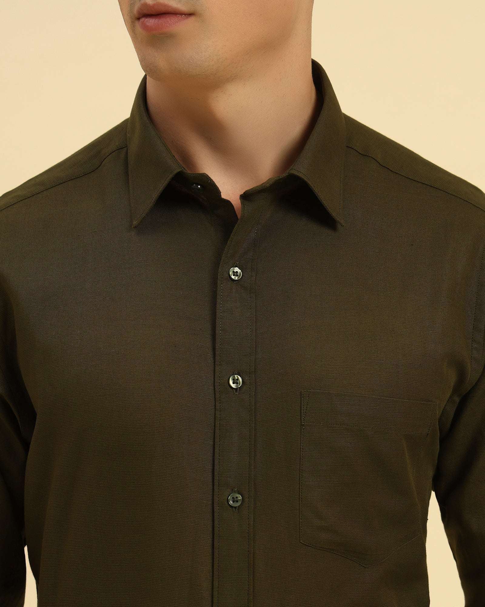 Close-up of the pointed collar and premium Italian cotton-linen fabric texture on the Aeternum Men's Dark Green Shirt.