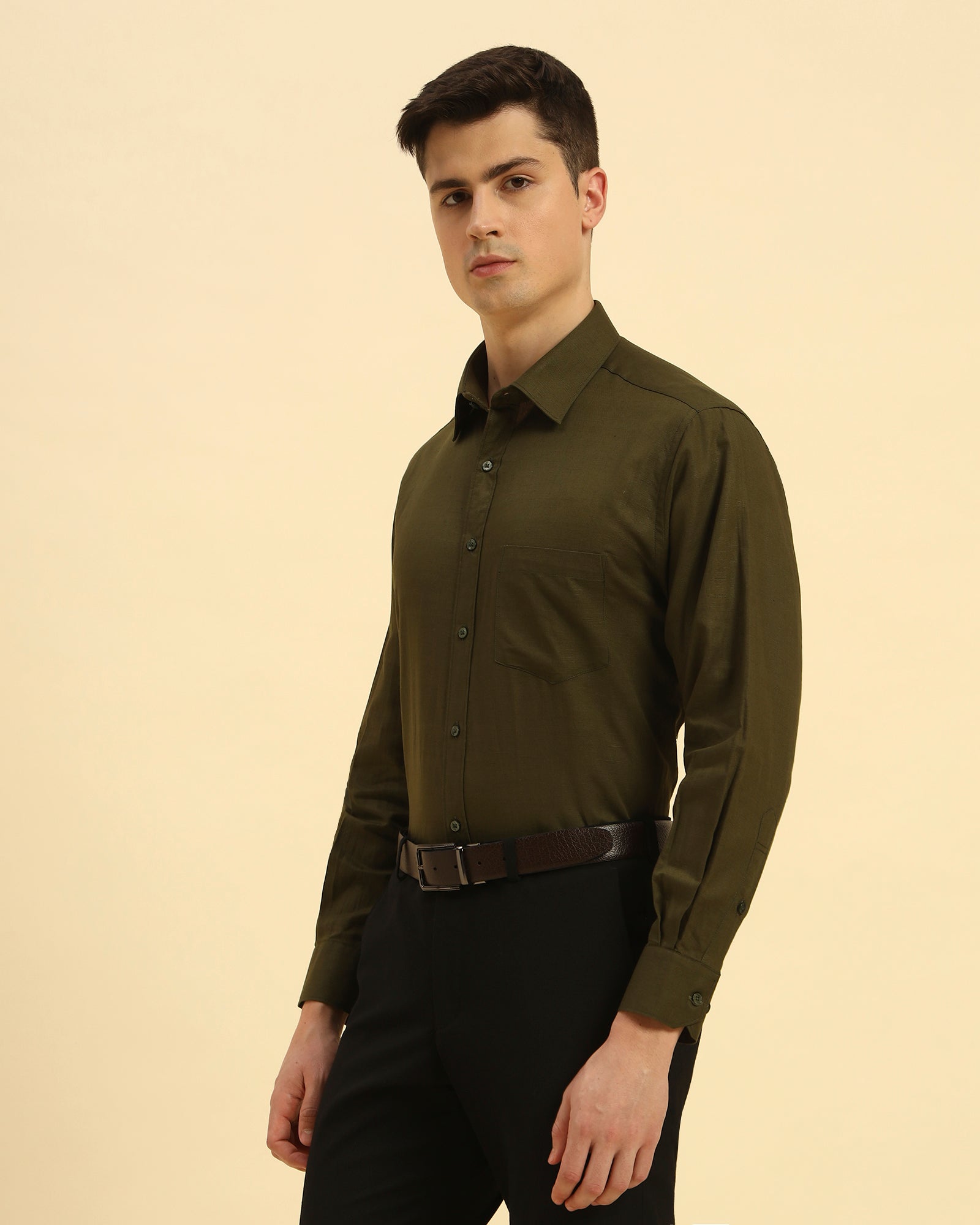 Three-quarter profile of the Men's Dark Green Cotton-Linen Shirt highlighting the effortless drape and relaxed silhouette.