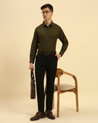 Model seated wearing the Dark Green Aeternum Italian Cotton-Linen Shirt, showcasing its versatility for both casual and formal settings