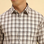 Close-up of the pointed collar and premium woven cotton texture on the Aeternum Men's White & Brown Checked Shirt.