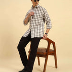 Model seated wearing the Aeternum Men's Classic Fit Checked Cotton Shirt, showcasing the shirt's versatility and comfortable drape.