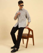 Model seated wearing the Aeternum Men's Classic Fit Checked Cotton Shirt, showcasing the shirt's versatility and comfortable drape.