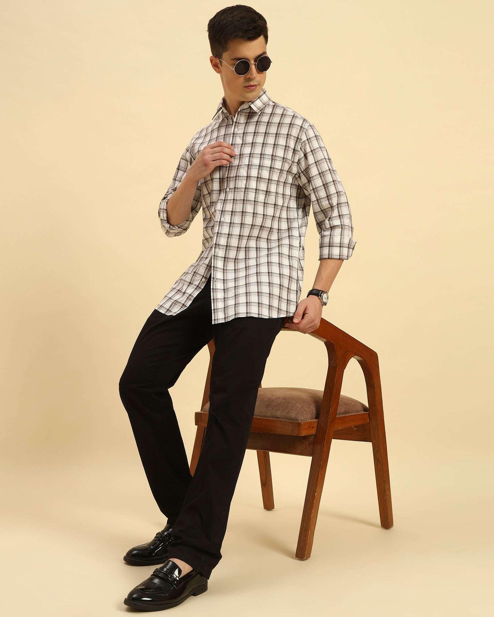 Model seated wearing the Aeternum Men's Classic Fit Checked Cotton Shirt, showcasing the shirt's versatility and comfortable drape.