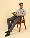 Model seated wearing the Aeternum Men's Classic Fit Textured Cotton-Blend Shirt, showcasing its breathable and stylish design.