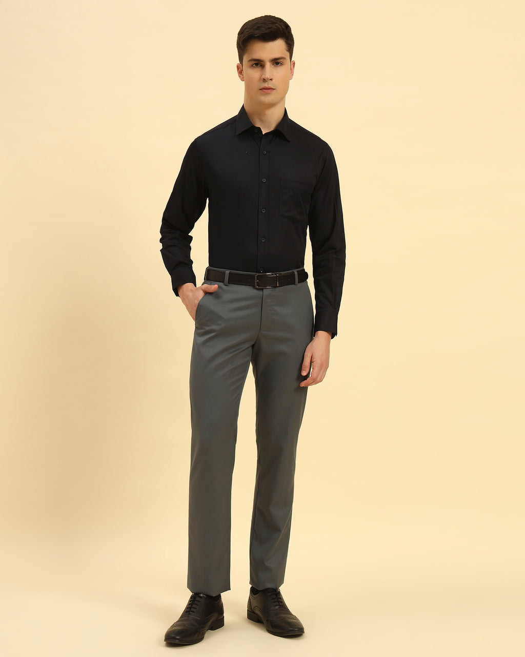 Full body view of the Aeternum Men's Navy Blue Slim Fit Shirt styled with grey trousers for a professional office look.