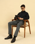 Model seated wearing the Navy Blue Aeternum Slim Fit Stretch Blend Shirt, showcasing the fabric's flexibility and comfort.