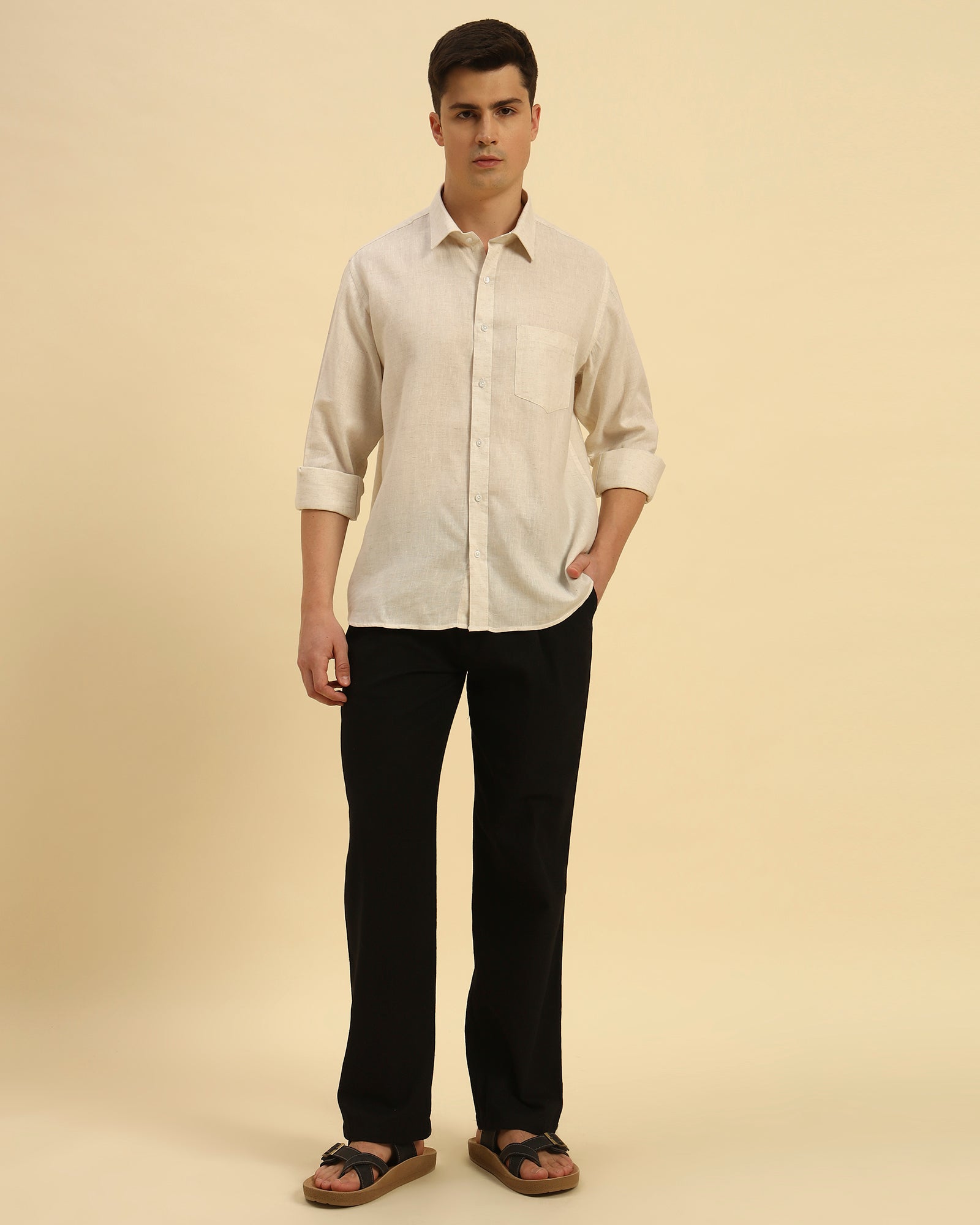 Full body view of the Beige Aeternum Relaxed Fit Salerno Shirt styled with black trousers for a sophisticated summer look.