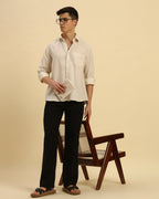 Model seated wearing the Beige Aeternum Relaxed Fit Salerno Shirt, showcasing its versatility for smart-casual wear.