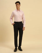 Full body view of the Aeternum Men's Light Pink Textured Shirt styled with dark trousers for a smart-casual aesthetic.