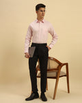 Model seated wearing the Light Pink Aeternum Classic Fit Textured Cotton Shirt, showcasing the fabric's soft drape and versatility.