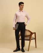 Model seated wearing the Light Pink Aeternum Classic Fit Textured Cotton Shirt, showcasing the fabric's soft drape and versatility.