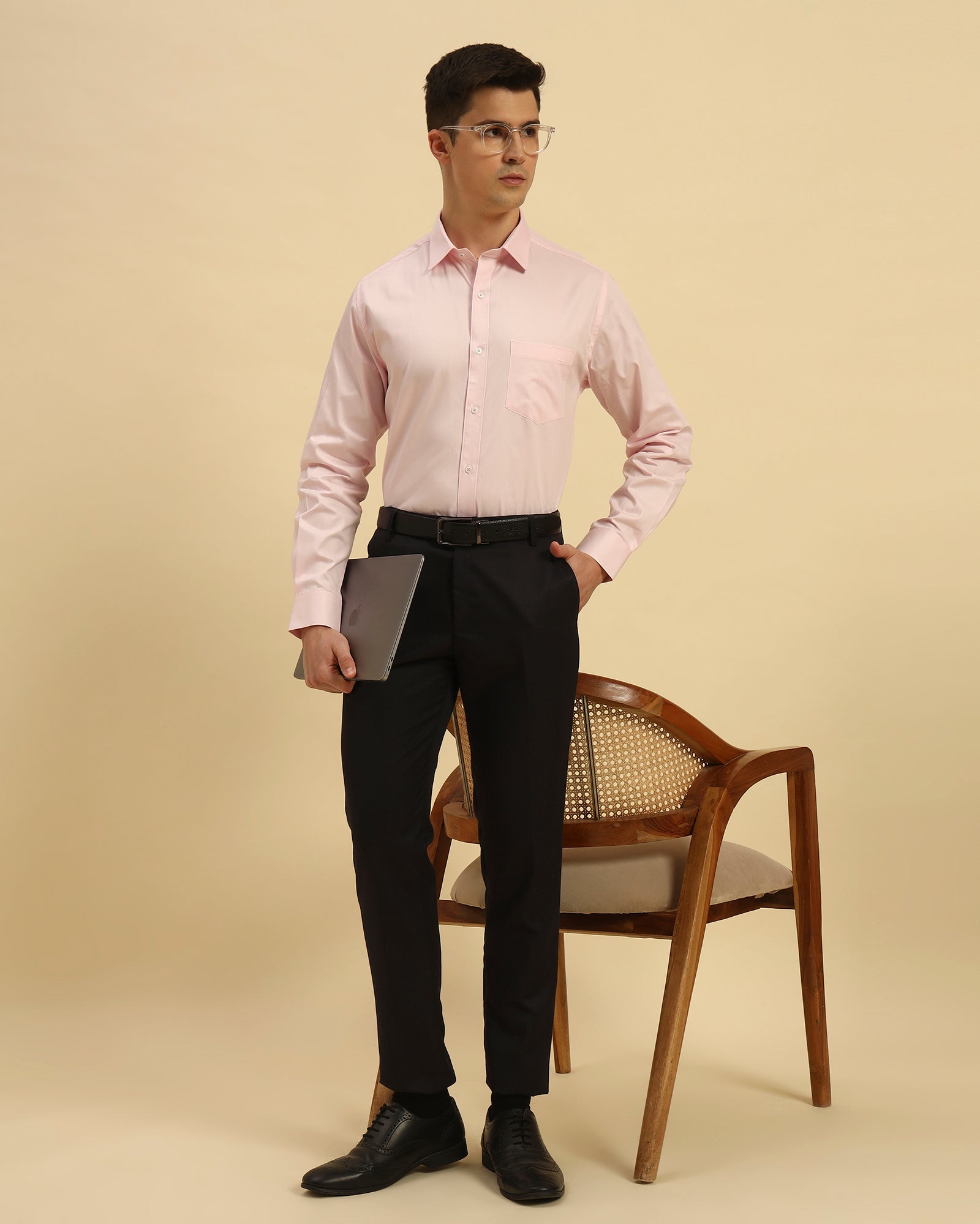 Model seated wearing the Light Pink Aeternum Classic Fit Textured Cotton Shirt, showcasing the fabric's soft drape and versatility.