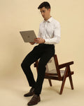 Model seated with a laptop wearing the Aeternum Men's White Giza Cotton Satin Shirt, showcasing its professional and versatile aesthetic.