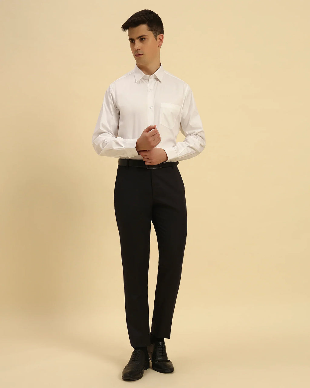 Full body view of the Aeternum Men's White Oxford Shirt styled with dark trousers for a timeless, professional look.