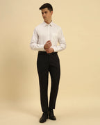 Full body view of the Aeternum Men's White Oxford Shirt styled with dark trousers for a timeless, professional look.