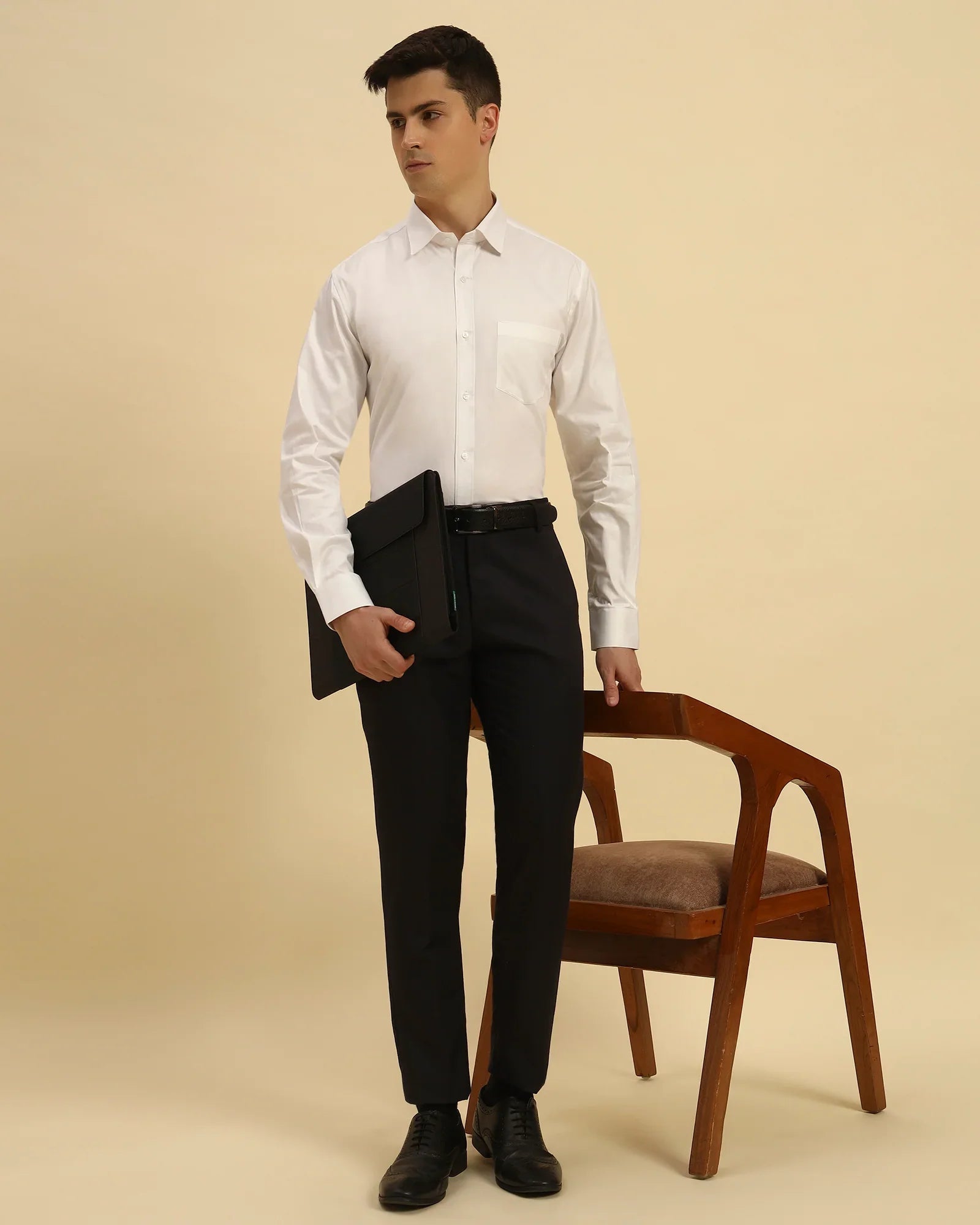 Model seated wearing the Aeternum Men's Classic Fit Oxford Cotton Shirt, showcasing its versatility for business-casual attire.